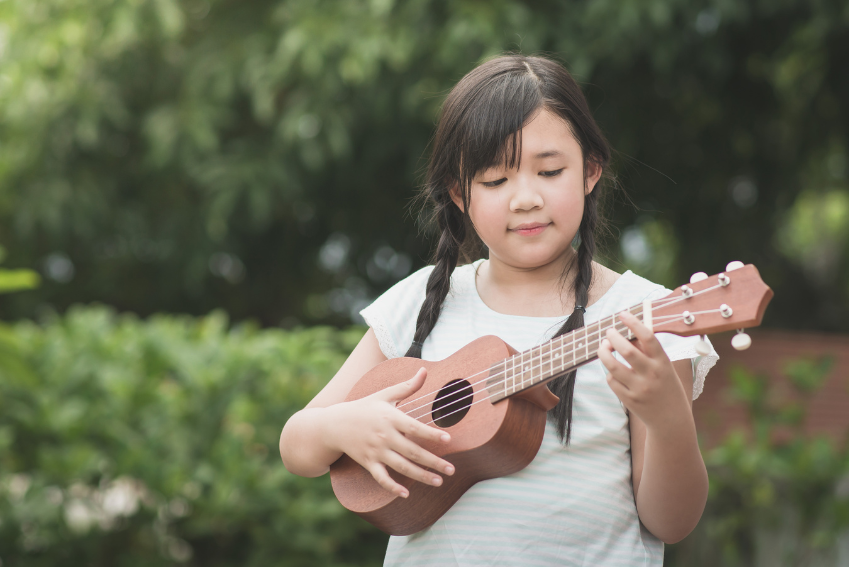 child playing the ukulele