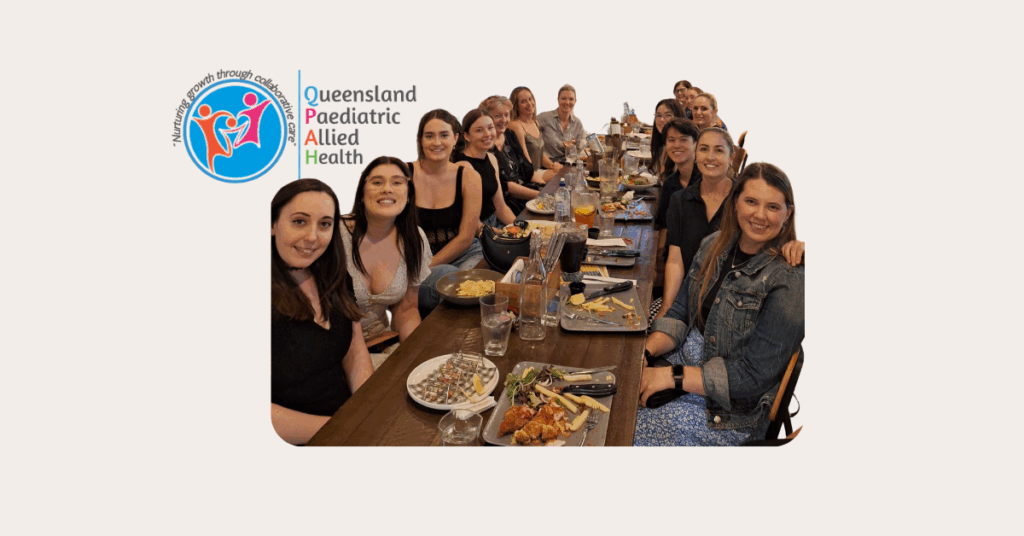 A group of men and women sitting around a long table.
