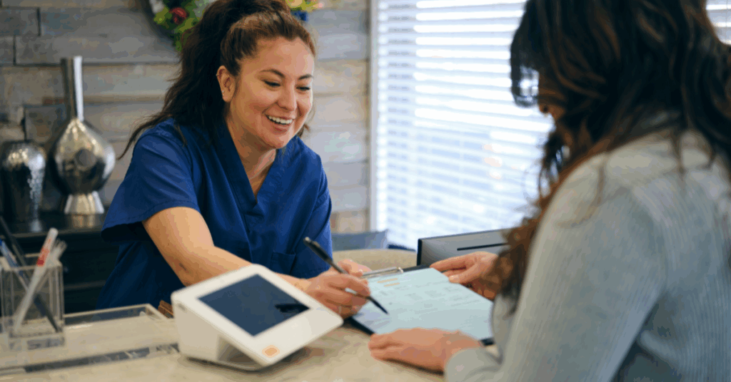 A receptionist assisting a client.