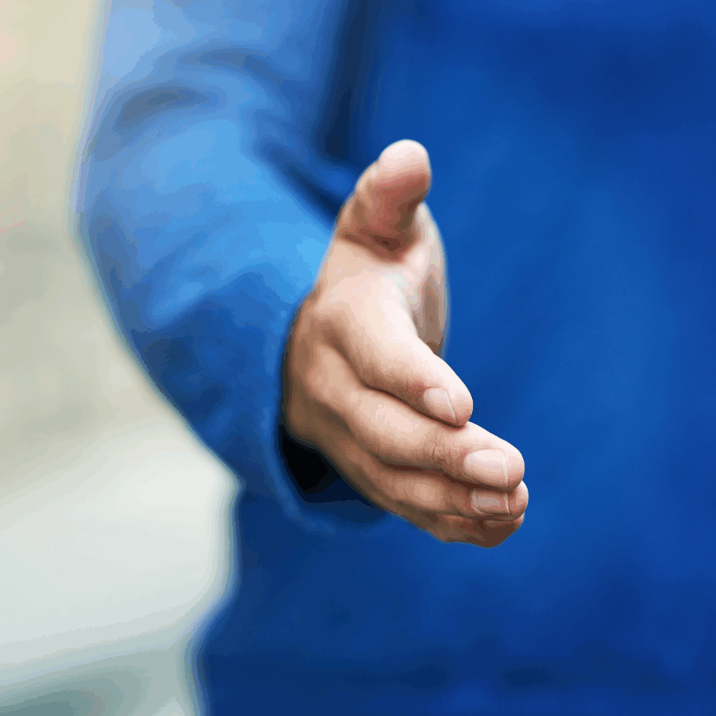 A close-up photo a person with a plue jumper reaching out for a handshake.