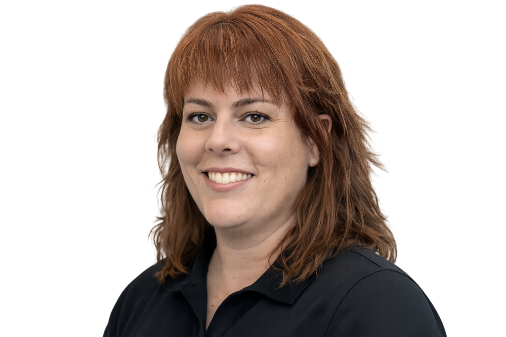 Photo of Kristy Waugh, a woman with shoulder length reddish-brown hair.