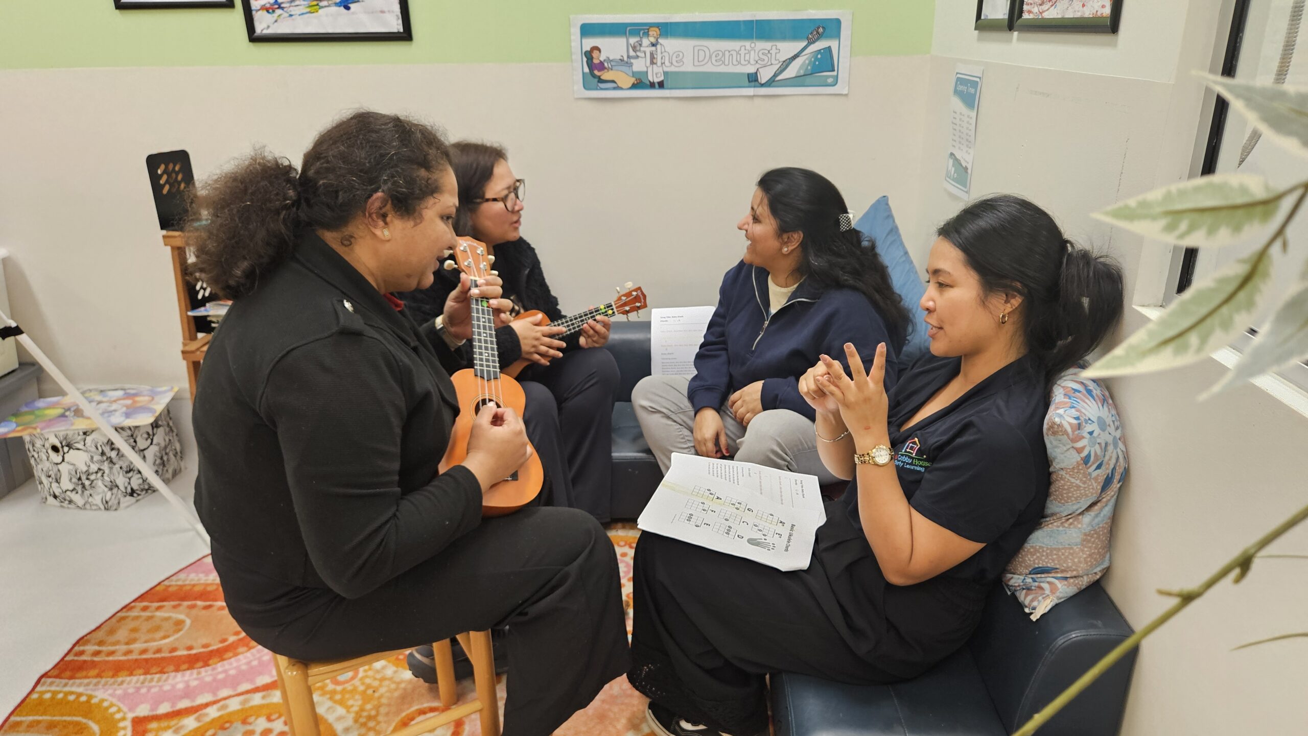 Early learning partnership participants engaging in a ukulele workshop