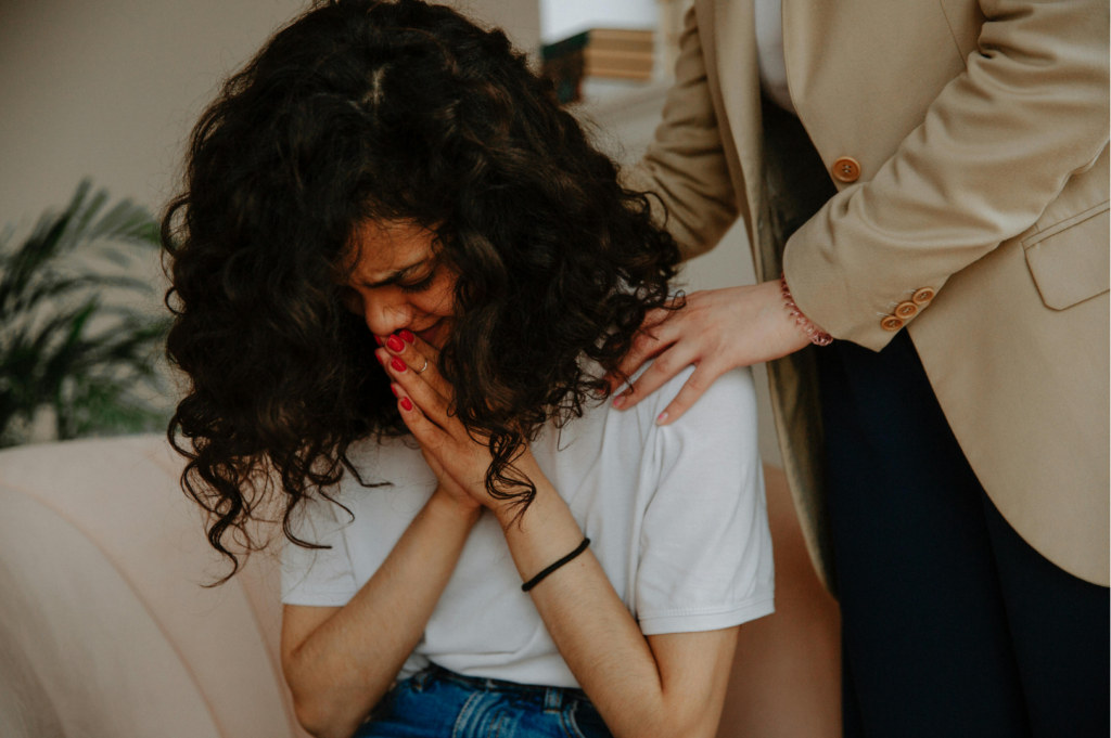 Friend comforting young woman